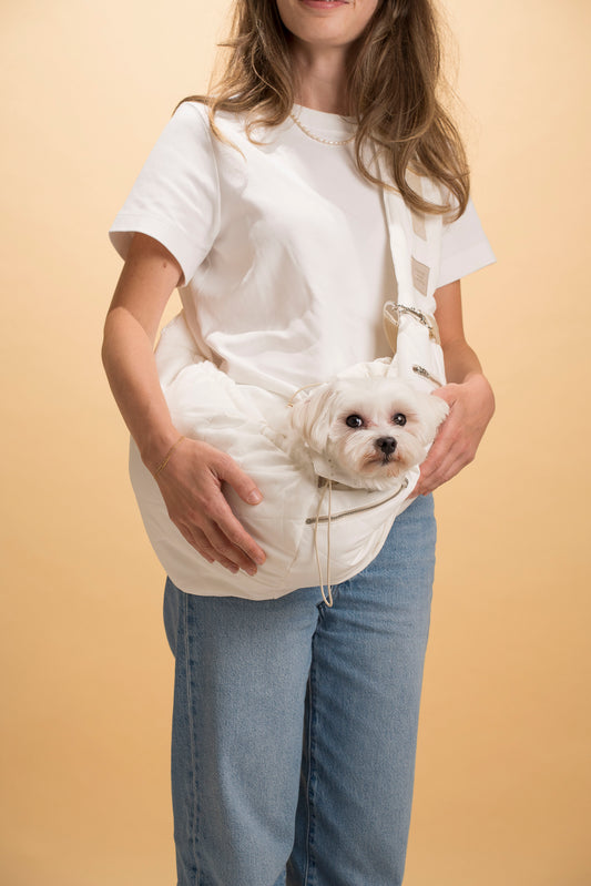 Adjustable pet sling carrier for small dogs and cats, perfect for travel.