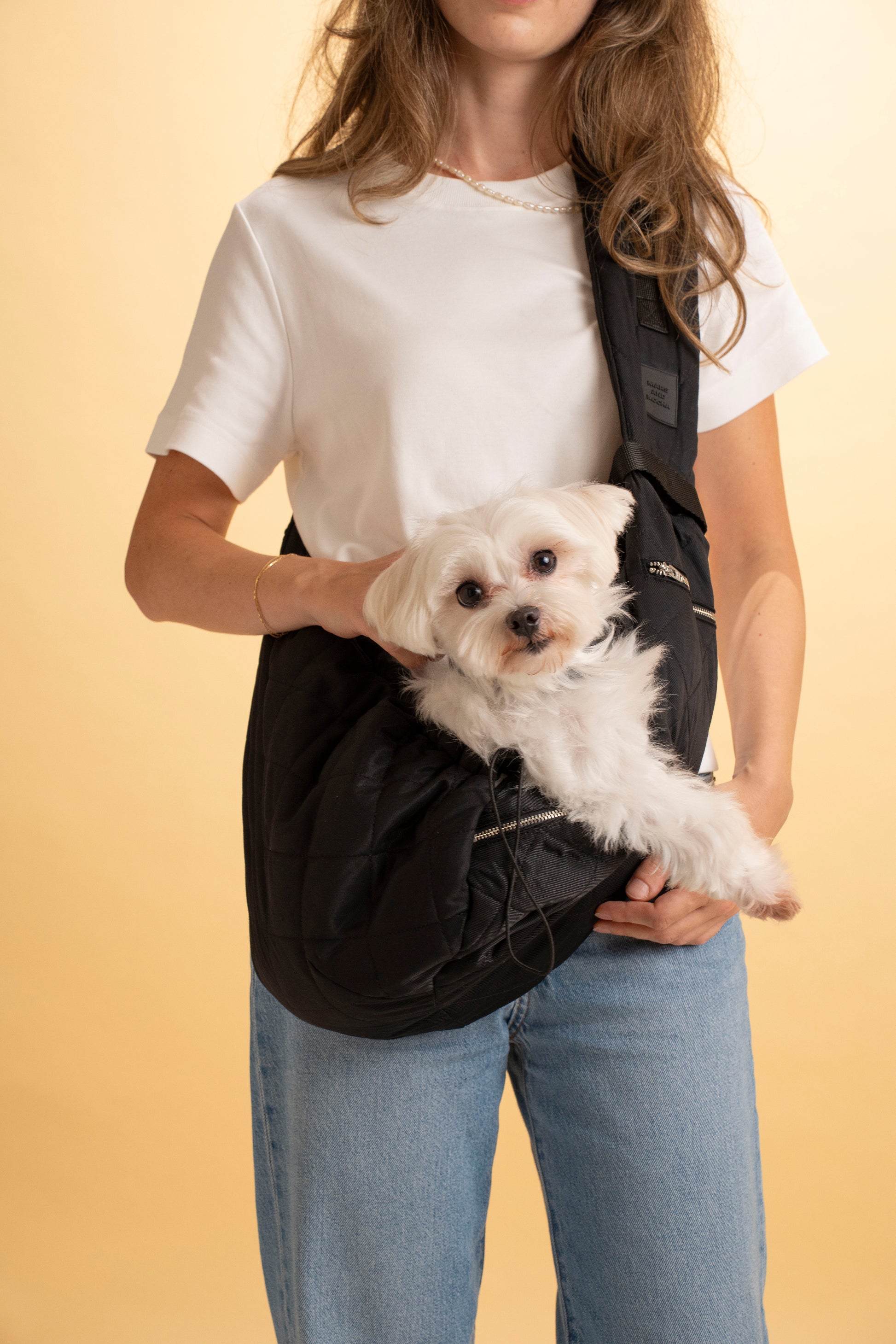 Stylish black dog sling carrier perfect for travel and daily walks.