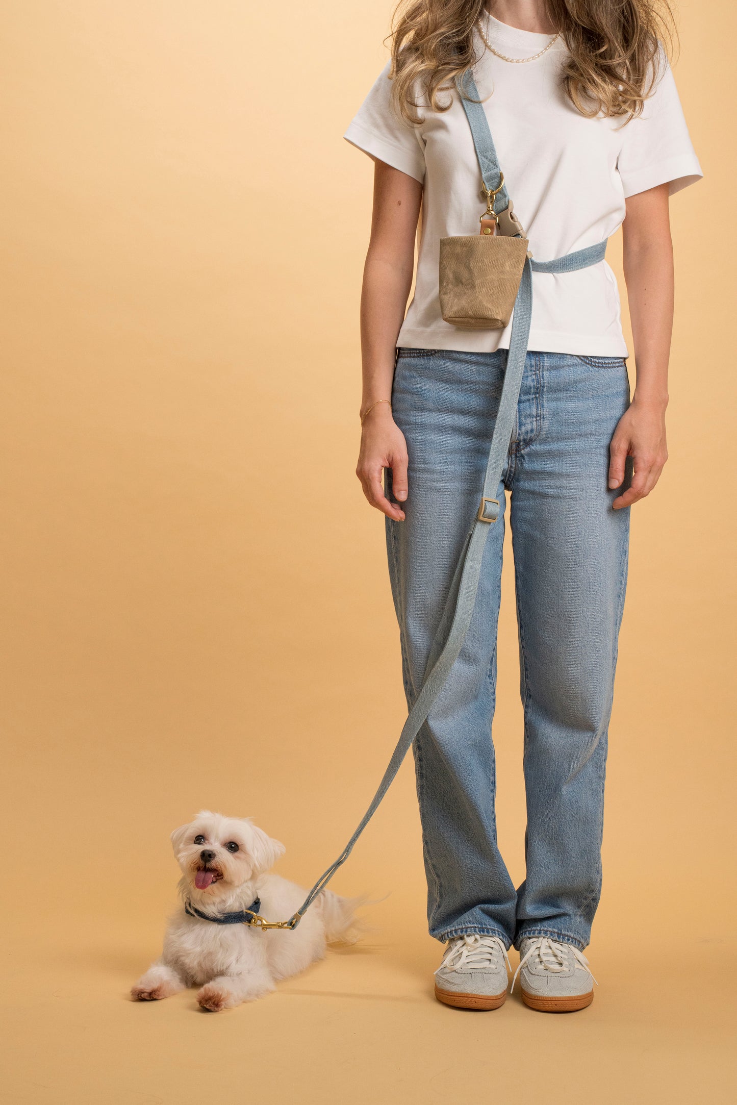 Jogging and hiking dog leash made from denim fabric with a brass D-ring for attachments.