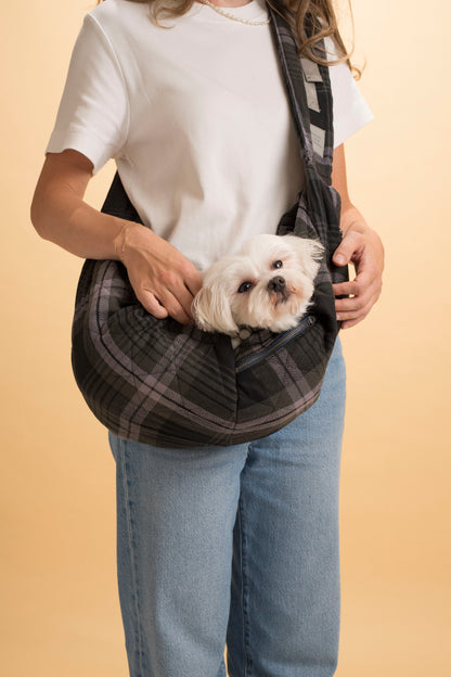 Compact and foldable pet sling carrier for easy storage and travel.