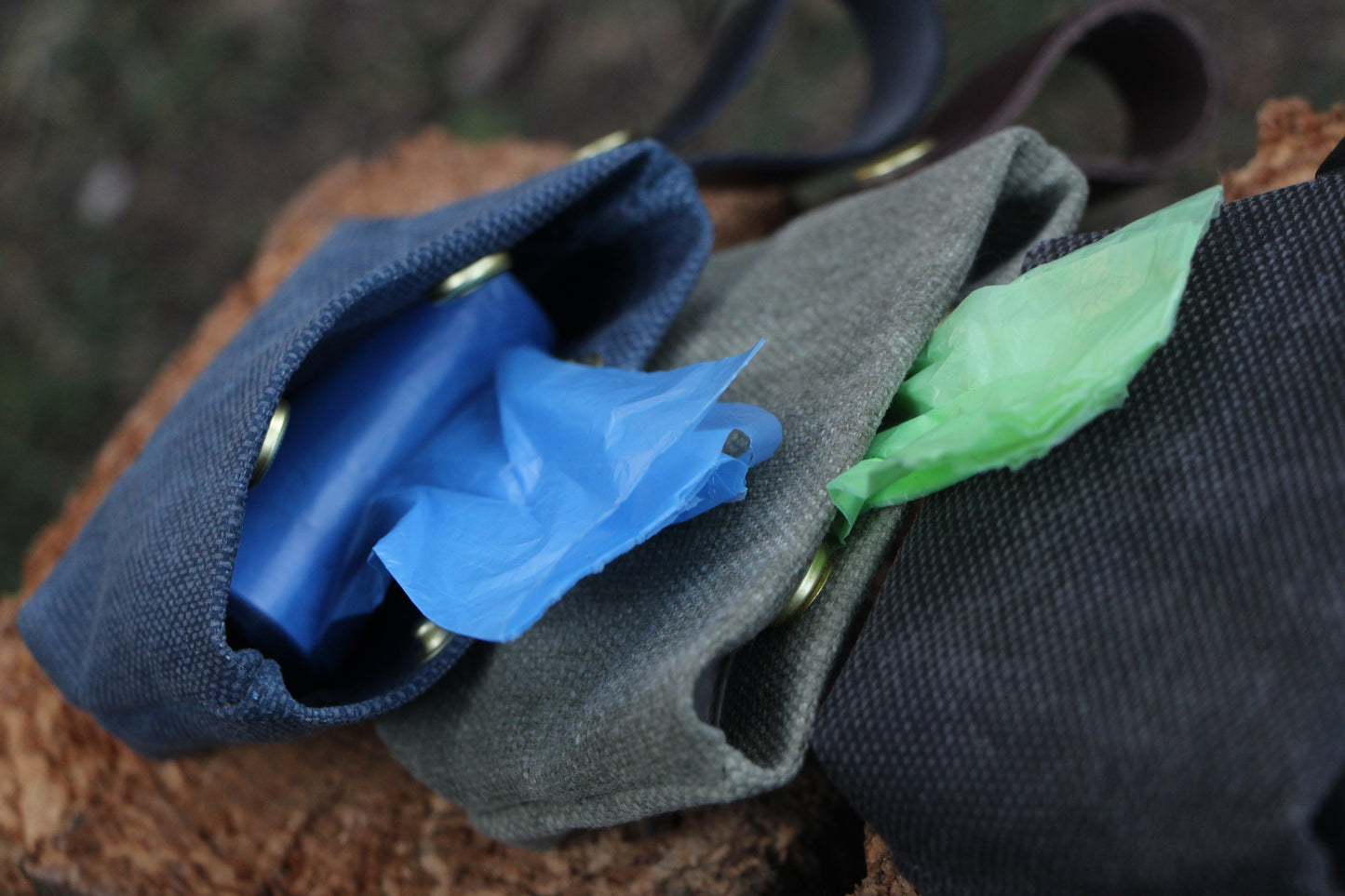 Inside the poop bag holder, two snap buttons hold the waste bag in place, allowing the bag to be pulled through between the snaps for easy access.