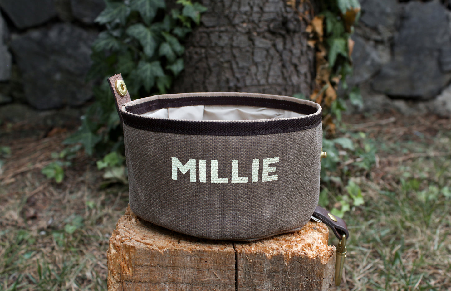 Oval dog bowl with custom-painted name, perfect for travel.