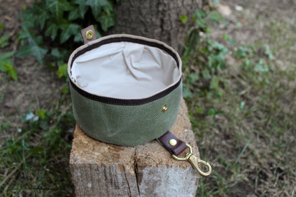 Green-colored collapsible travel dog bowl for easy feeding on the go.