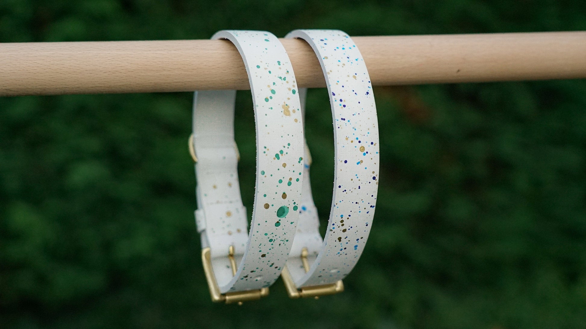 White leather pet collar with green&gold and blue&gold accents.